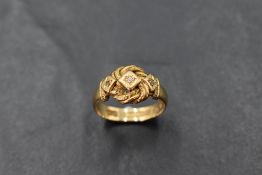 An 18ct gold and diamond chip ring in star burst setting in a knot mount, size O and approx 4.8g.