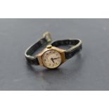 A lady's 9ct gold wrist watch by Bernex having Arabic numeral dial in gold case on black leather