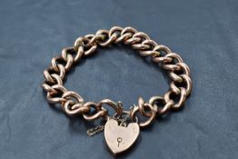 A rose gold curb link bracelet having padlock clasp and bearing stamp 9C on each link, approx 18.7g