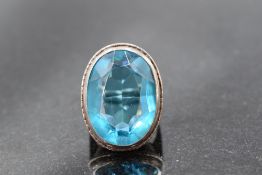A large turquoise paste ring in a collared mount on a white metal loop stamped silver, size N &