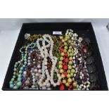 A selection of vintage strings of beads including yellow wire and bead, mother of pearl, glass,