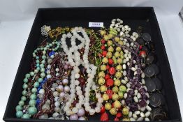 A selection of vintage strings of beads including yellow wire and bead, mother of pearl, glass,