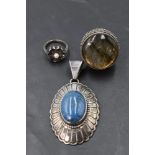 An American lapis lazuli oval pendant in a silver decorative mount bearing makers mark for Leonard
