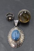 An American lapis lazuli oval pendant in a silver decorative mount bearing makers mark for Leonard