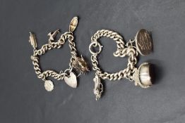 Two HM silver and white metal charm bracelets, one having three oversized charms, including watch