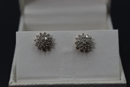 A pair of diamond chip cluster stud earrings on 9ct gold mounts