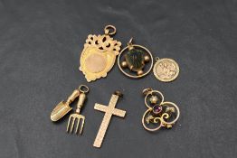 Six 9ct gold pendants and charms including scarab beetle, medalion, St Christopher, Edwardian,