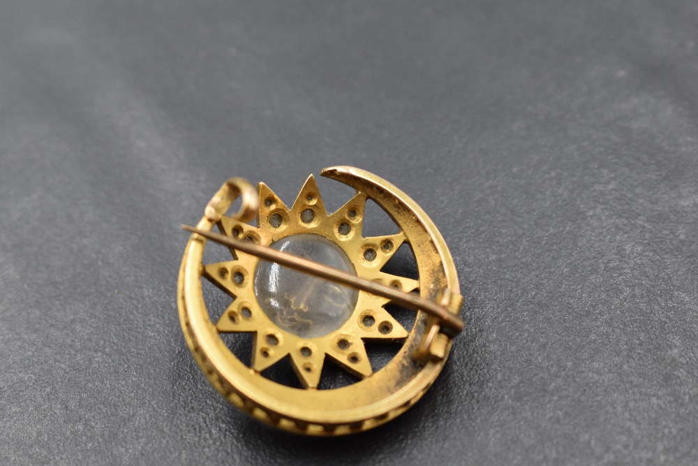 A yellow metal, diamond chip, pearl and carved moonstone crescent and sun brooch, the crescent - Image 2 of 2