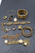 A tray of rolled gold jewellery including a hinged cuff bangle, coiled snake bangle, pendant, an