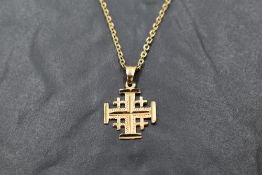 A yellow metal cross pendant marked 18K and bearing inscription Jerusalem en verso, on a 9ct gold