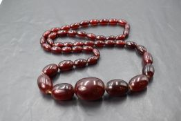 A string of cherry amber style graduated oval beads, approx 26'