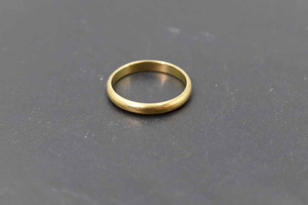 A yellow metal wedding band stamped 18K bearing inscription Proctor's Lucky to the inside, size