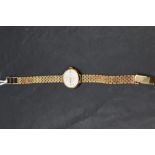 A lady's 9ct gold wrist watch by Rotary having a baton dial to champagne face in gold case with long