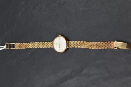 A lady's 9ct gold wrist watch by Rotary having a baton dial to champagne face in gold case with long