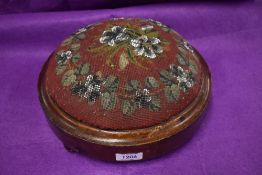 A Victorian button form foot stool with bead worked top