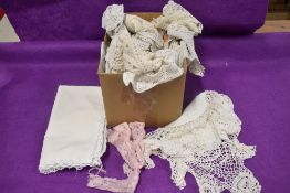 A box full of vintage and antique crotchet edging and similar.