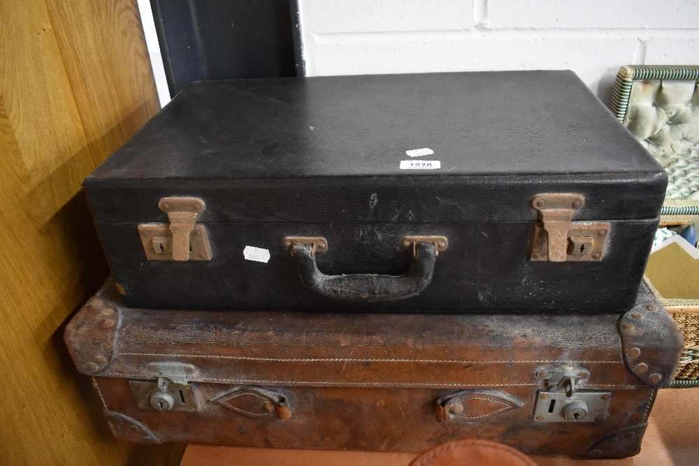 Two vintage suitcases in used condition.