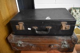 Two vintage suitcases in used condition.