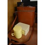 A vintage lunch box including flask, cups and sandwich box.