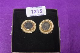 A pair of modern clip on earrings with Roman style coins inserted