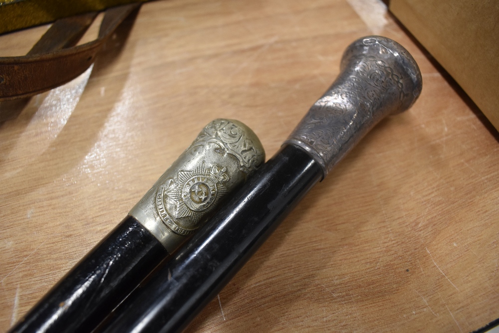 Two early 20th century walking canes, one having hm silver top and the other marked for Lancashire