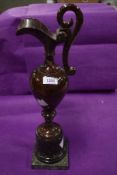 A Victorian red granite ornamental ewer on stand, AF.