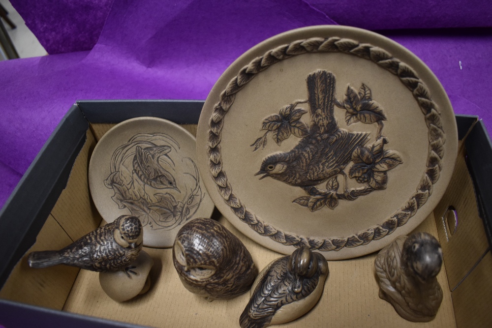 A selection of Poole pottery in a brown glaze including animal studies and plates