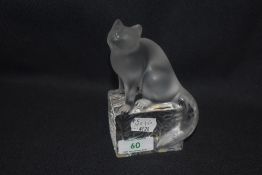 A 20th century Lalique clear cut crystal glass figure study of a cat perched upon a wall, signed