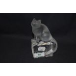 A 20th century Lalique clear cut crystal glass figure study of a cat perched upon a wall, signed
