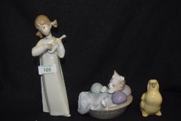 A modern Lladro figure study of a girl playing lute having damage to head, and two Nao figures one