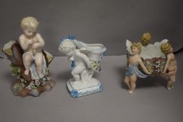 Three antique German porcelain cherub design pieces including table centre, spoon warmer and a vase