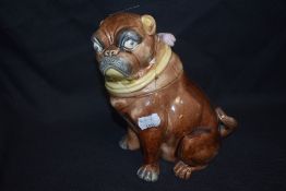 An antique Majolica tobacco jar in the form of a Pug dog, Lid having had repairs
