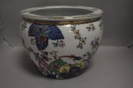 A 20th century Chinese fish bowl hand decorated with enamels having fish and peacock design 21cm