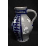 An early 20th century vintage Mettlach style water jug