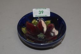A 20th century Moorcroft pottery pin dish with deep blue glaze and Anemone design