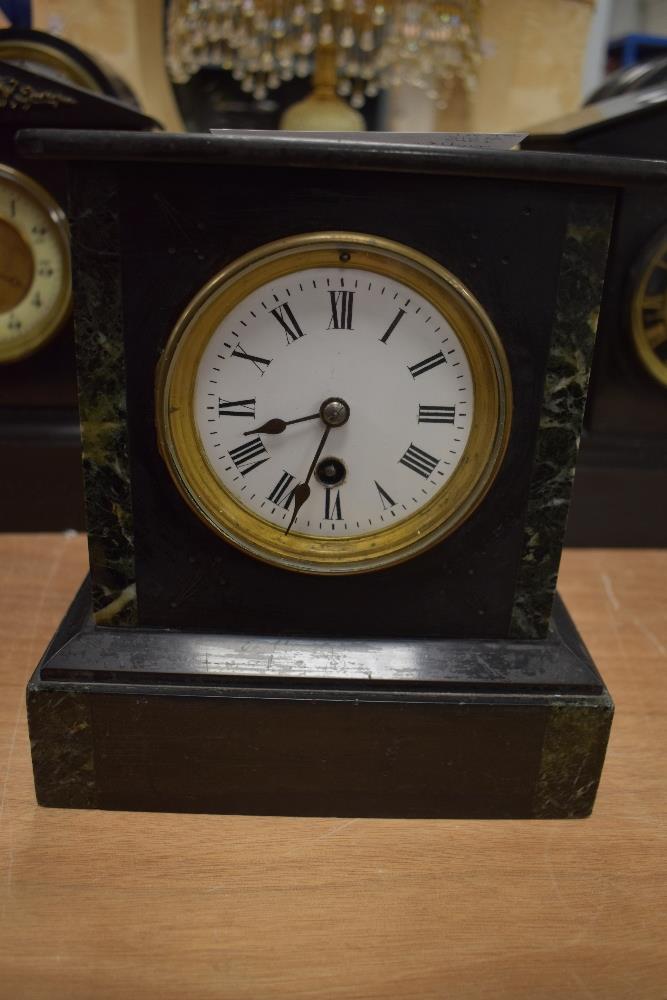 A Victorian French slate mantel clock with marble inserts and enamel dial