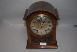 An Edwardian bracket clock having mahogany case with fret worked frontage domed dial and chime