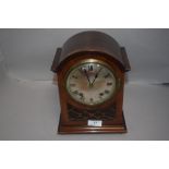 An Edwardian bracket clock having mahogany case with fret worked frontage domed dial and chime