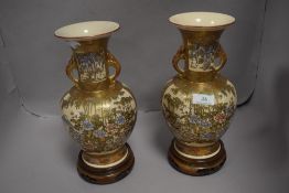 A mirrored pair of 19th century Japanese Satsuma vase, very highly decorated with gilt scenes of a