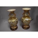 A mirrored pair of 19th century Japanese Satsuma vase, very highly decorated with gilt scenes of a