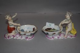 Two early 19th century Meissen marked porcelain salt cellars with Putti style figures and