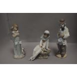 Modern figure studies including Lladro girl holding cat, Lladro Clown playing saxaphone and Nao