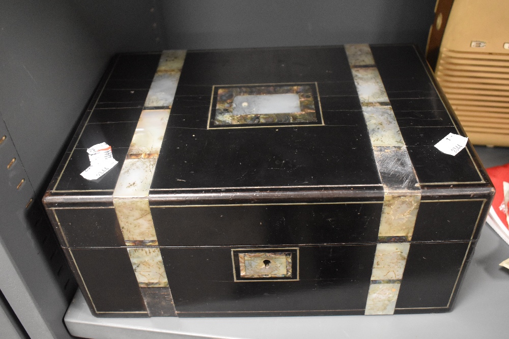 A late Victorian sewing box having ebony veneer case with mother of pearl inlayed banding, with some
