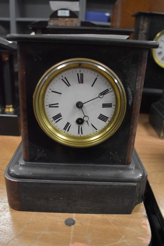 A Victorian French slate mantel clock with red marble inserts having damage to base