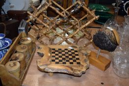 A selection treen wood items including a bamboo bottle rack, a spice jar set and a burr wood games
