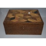 An early 20th century fitted sewing case with a sample wood parquetry veneer top on a fine oak