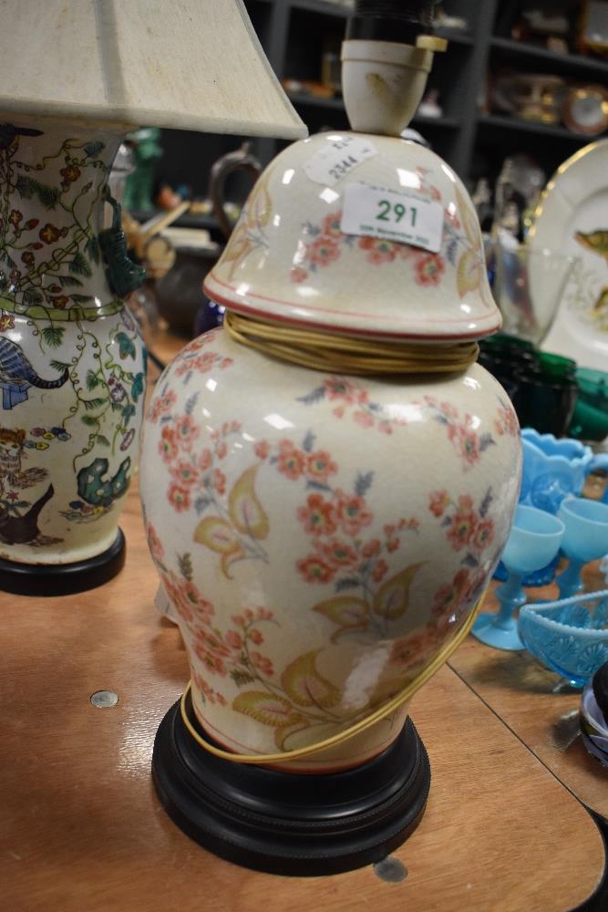 An early 20th century urn form lamp base having hand decorated floral design