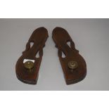 A pair of early 20th century Indian wooden craved knob toe slippers with inlayed brass decoration