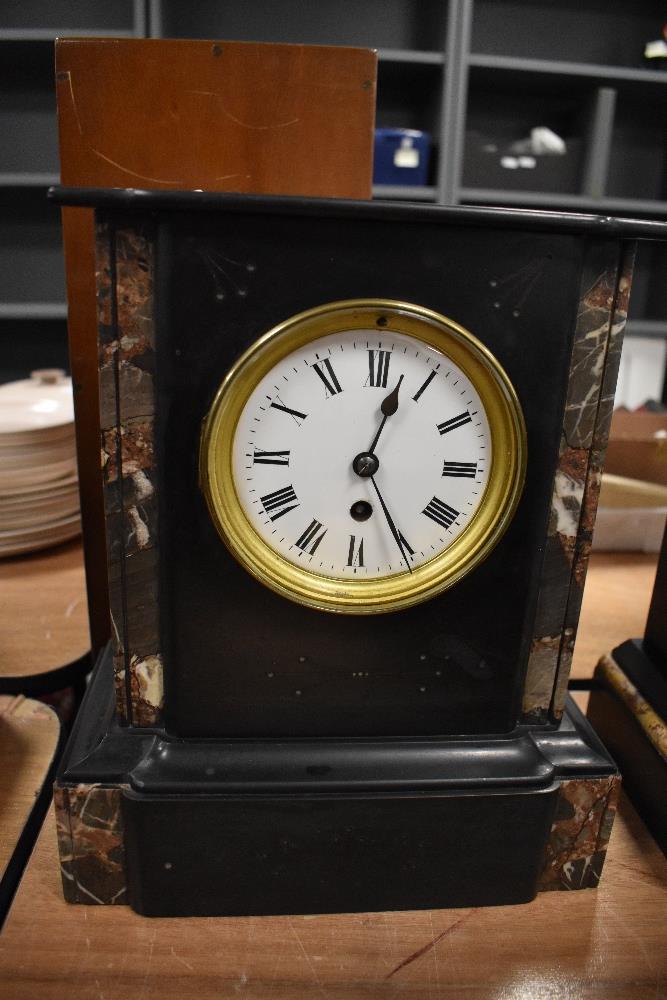 A Victorian French mantel clock having marble inserts and enamel dial