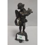 An antique bronze figure study of a cherub playing a lute on four footed plinth. 14cm tall